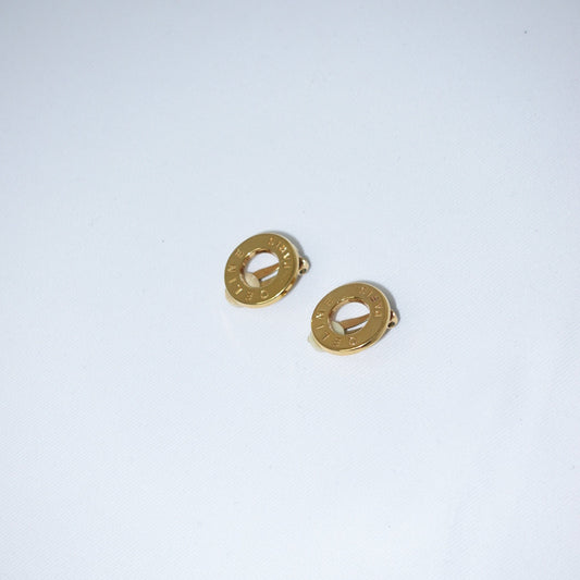 Pair of gold earrings on a light gray background