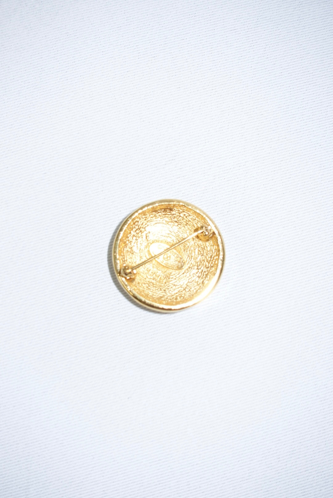 146. Chanel Vintage Clip Gold-Toned Round Logo Brooch