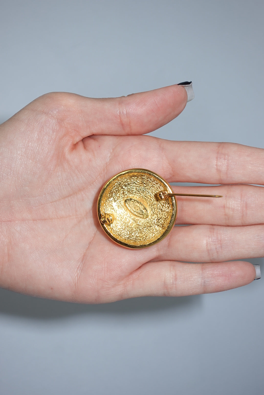 146. Chanel Vintage Clip Gold-Toned Round Logo Brooch