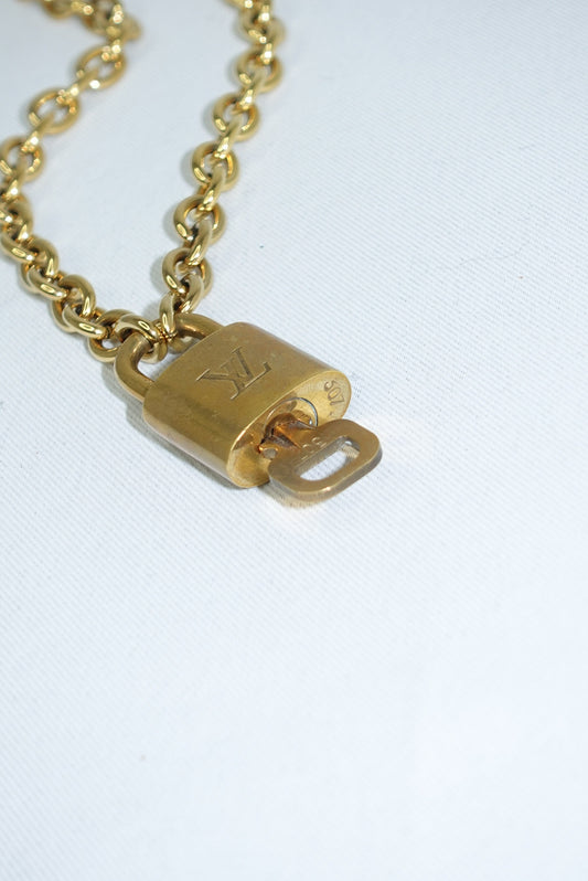 180. Louis Vuitton Gold Toned Vintage Lock Neckace