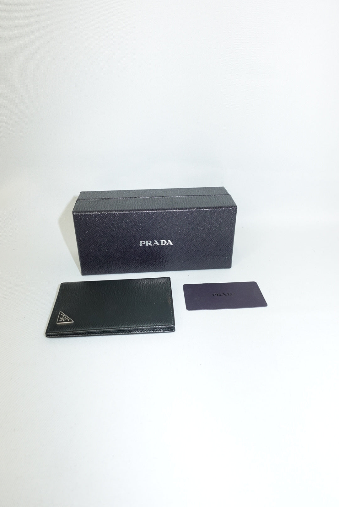 Prada black leather card holder with iconic silver logo and original box