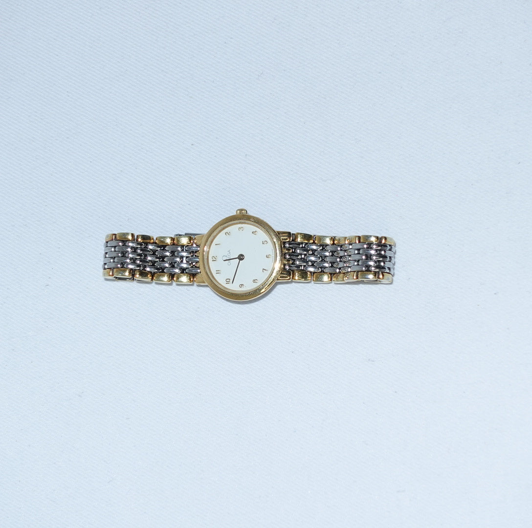     Classic Omega De Ville quartz watch in silver and gold with a round white dial.