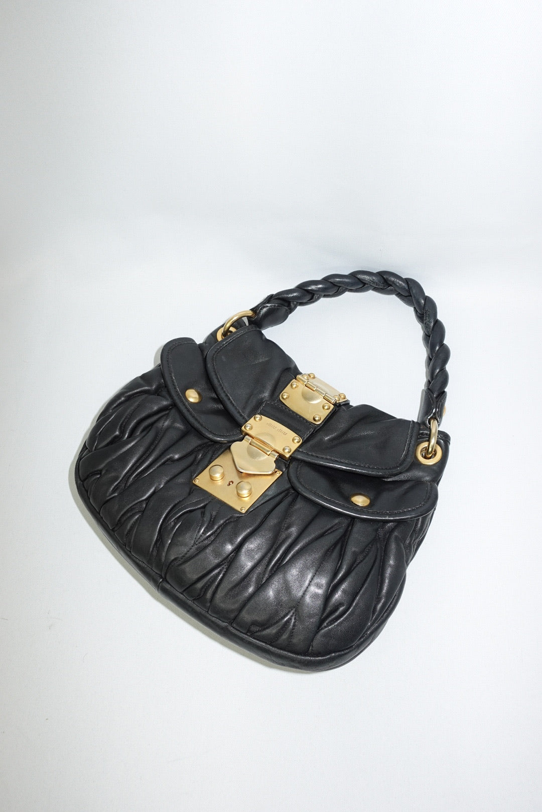 Miu Miu vintage black matelassé small coffer shoulder bag on white background