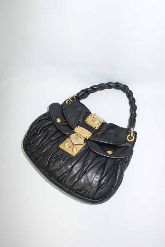 Miu Miu vintage black matelassé small coffer shoulder bag on white background