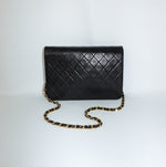 Vintage Chanel black leather single flap bag with diamond quilting and CC closure