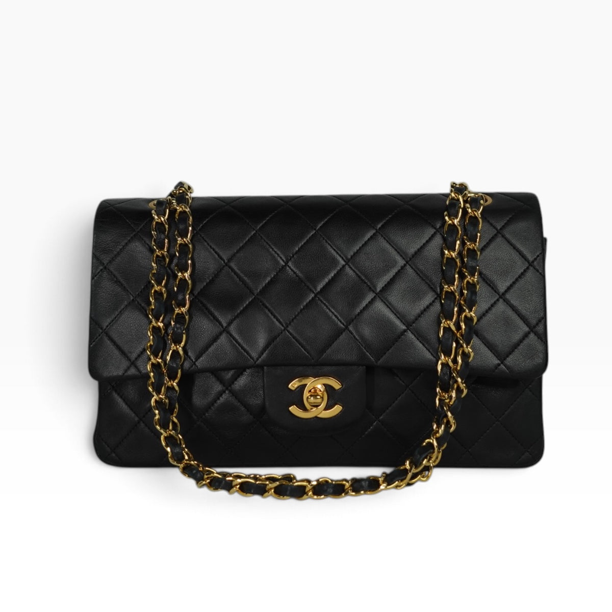 Chanel Vintage Timeless Classic 25 Double Flap Bag in black quilted lambskin leather with iconic CC turn-lock closure and 24k gold-plated hardware.