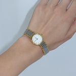     Elegant Omega De Ville watch featuring a white dial and two-tone stainless steel bracelet.