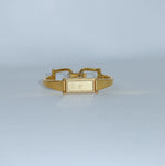 Vintage Gucci 1500L gold-tone watch with a rectangular gold dial