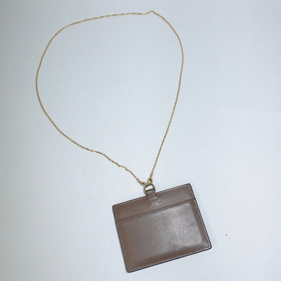 Authentic Fendi card holder in brown leather with gold tone accents
