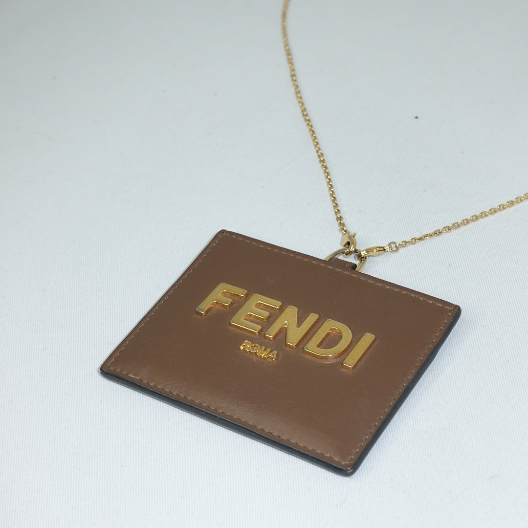 Luxury Fendi brown leather cardholder with gold details and chain strap