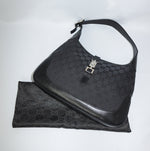 Gucci Vintage Jackie black shoulder bag in GG monogram canvas with silver hardware and leather trim, hobo style silhouette