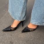 My Vintage Attire Chanel black leather and mesh slingback heels with pointed toe and embossed CC logo.