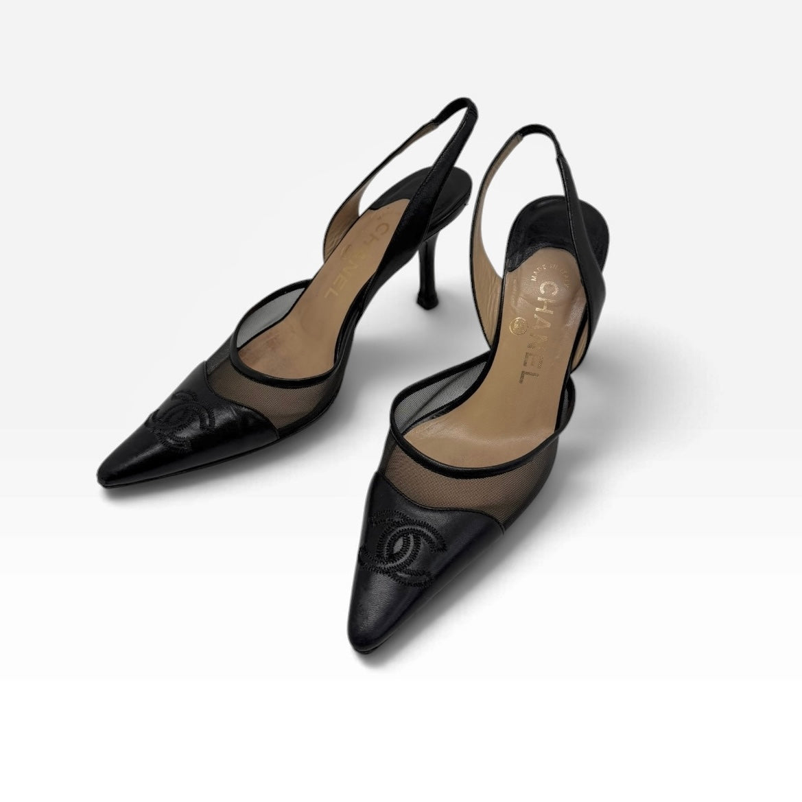 My Vintage Attire Chanel black leather and mesh slingback heels with pointed toes and embossed CC logo.