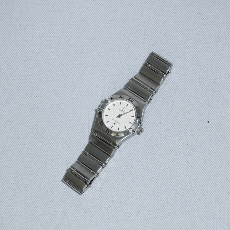 Side case detail of Omega Constellation Mini vintage watch showing stainless steel silver toned finish