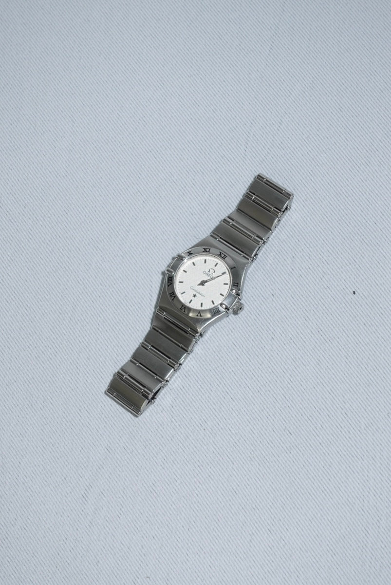 Side case detail of Omega Constellation Mini vintage watch showing stainless steel silver toned finish