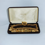 Vintage Celine gold-plated button charm necklace presented with original Celine box and signature medallion details