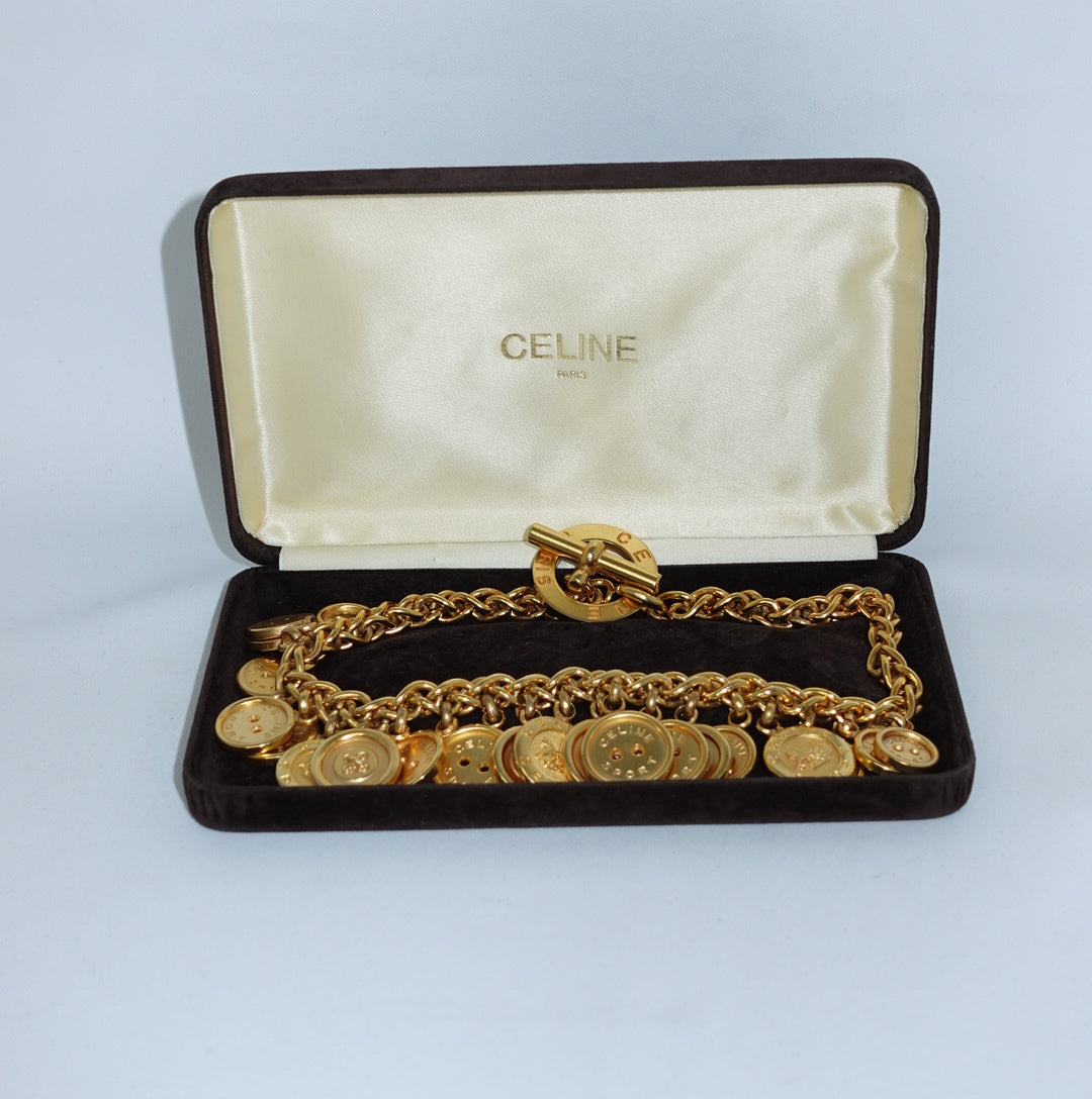 Vintage Celine gold-plated button charm necklace presented with original Celine box and signature medallion details