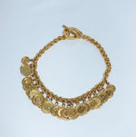 Vintage Celine gold-plated button charm necklace still life featuring chunky chain and signature medallion charms