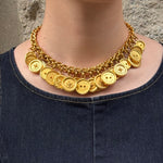 Vintage Celine gold-plated button charm necklace worn by model with chunky chain and signature medallion details