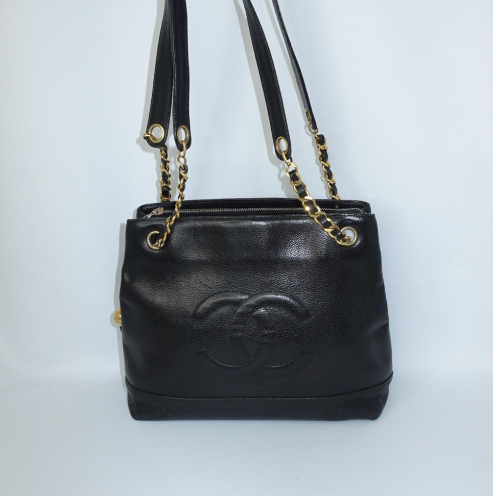 Chanel Black Caviar Leather Tote Bag  front view with oversized CC logo and gold chain straps