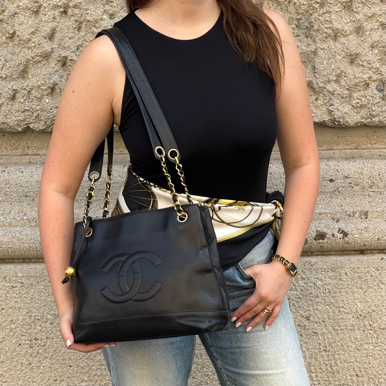 Chanel Black Caviar Leather Tote Bag worn front view with oversized CC logo and gold chain straps