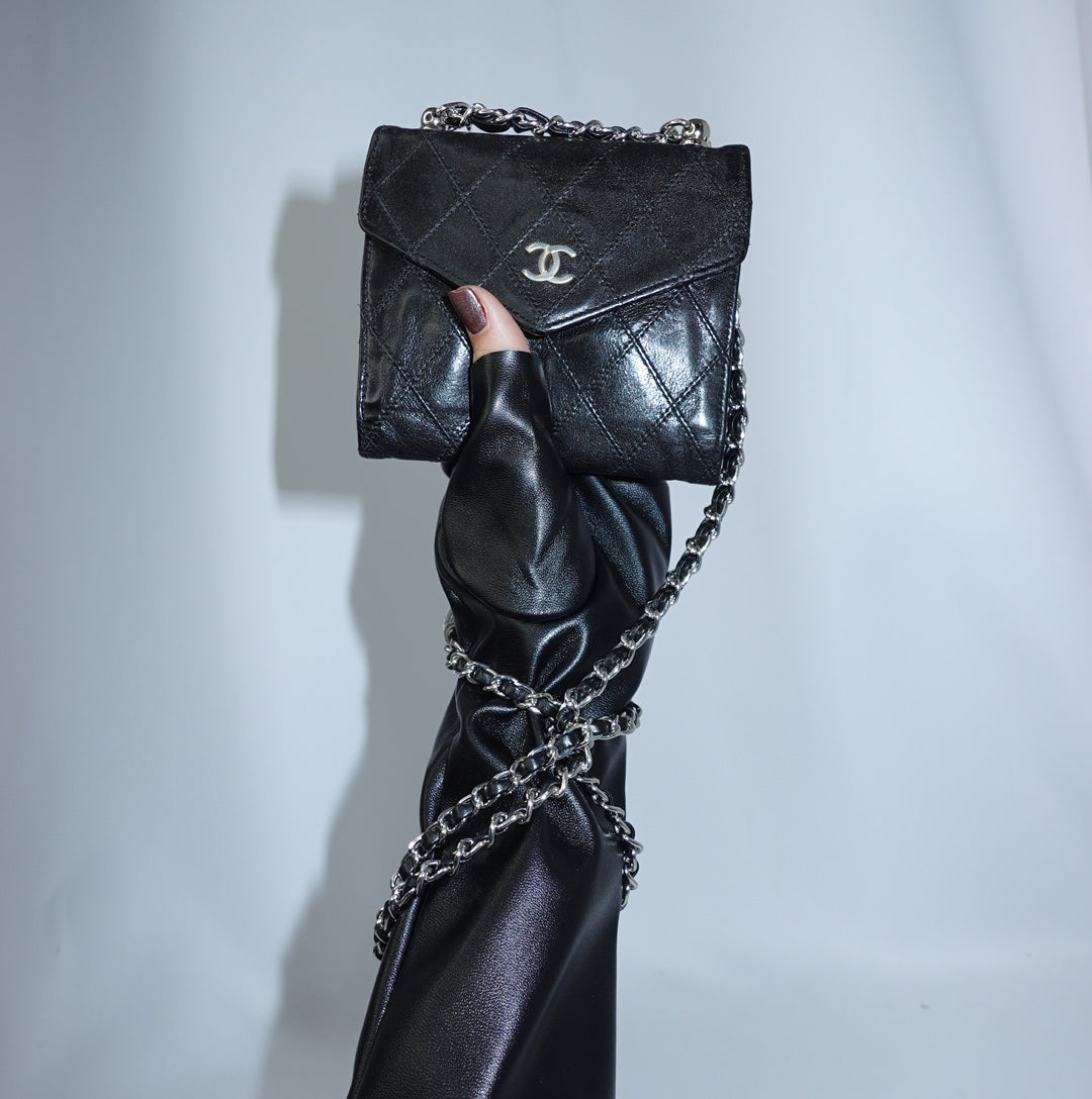 Chanel black mini wallet reworked with chain in leather featuring iconic CC logo front view.