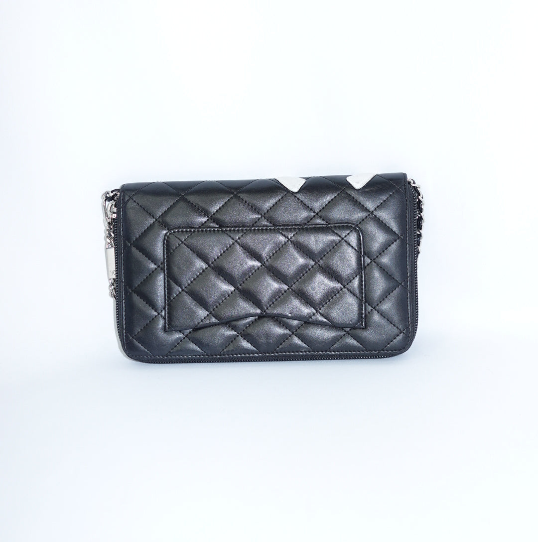 Back view of Chanel Cambon reworked wallet on chain in black leather with added silver chain strap.