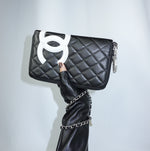 Vintage Chanel Cambon reworked wallet on chain in black leather with oversized white CC logo front view.