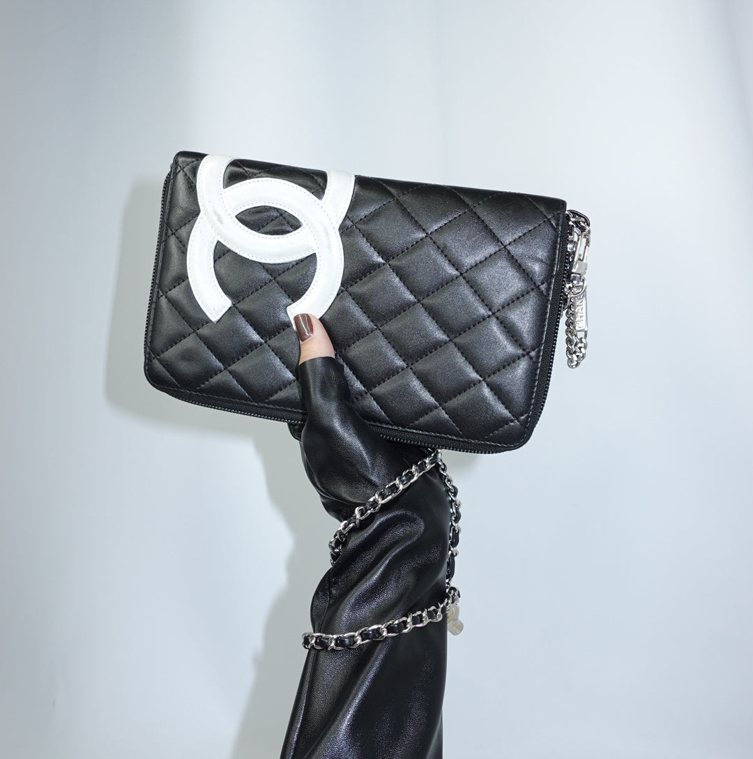 Vintage Chanel Cambon reworked wallet on chain in black leather with oversized white CC logo front view.