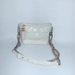 Chanel Gabrielle white leather Hobo Bag still life showing structured base and signature chain detaili