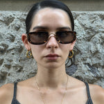 Front view of Christian Dior tortoiseshell rectangular sunglasses with brown tinted lenses and gold bridge detail.