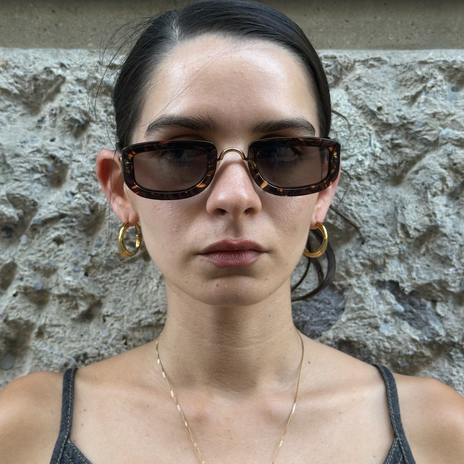 Front view of Christian Dior tortoiseshell rectangular sunglasses with brown tinted lenses and gold bridge detail.