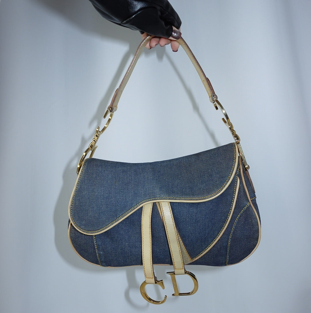 Dior Denim Double Saddle Bag in blue denim with beige leather trim and gold-tone hardware front view