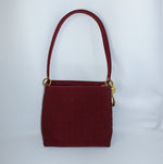 Front view of Dior Lady Dior Cannage red leather bag with gold-tone D.I.O.R. charms.