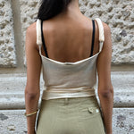Back view of Dolce & Gabbana cream sheer top with knotted straps and lightweight semi-sheer fabric construction.