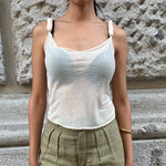Front view of Dolce & Gabbana cream sheer top featuring a draped neckline and knotted shoulder straps.