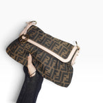 Vintage Fendi Chef Zucca handbag held in hand, showcasing the iconic FF monogram pattern and classic designer silhouette.