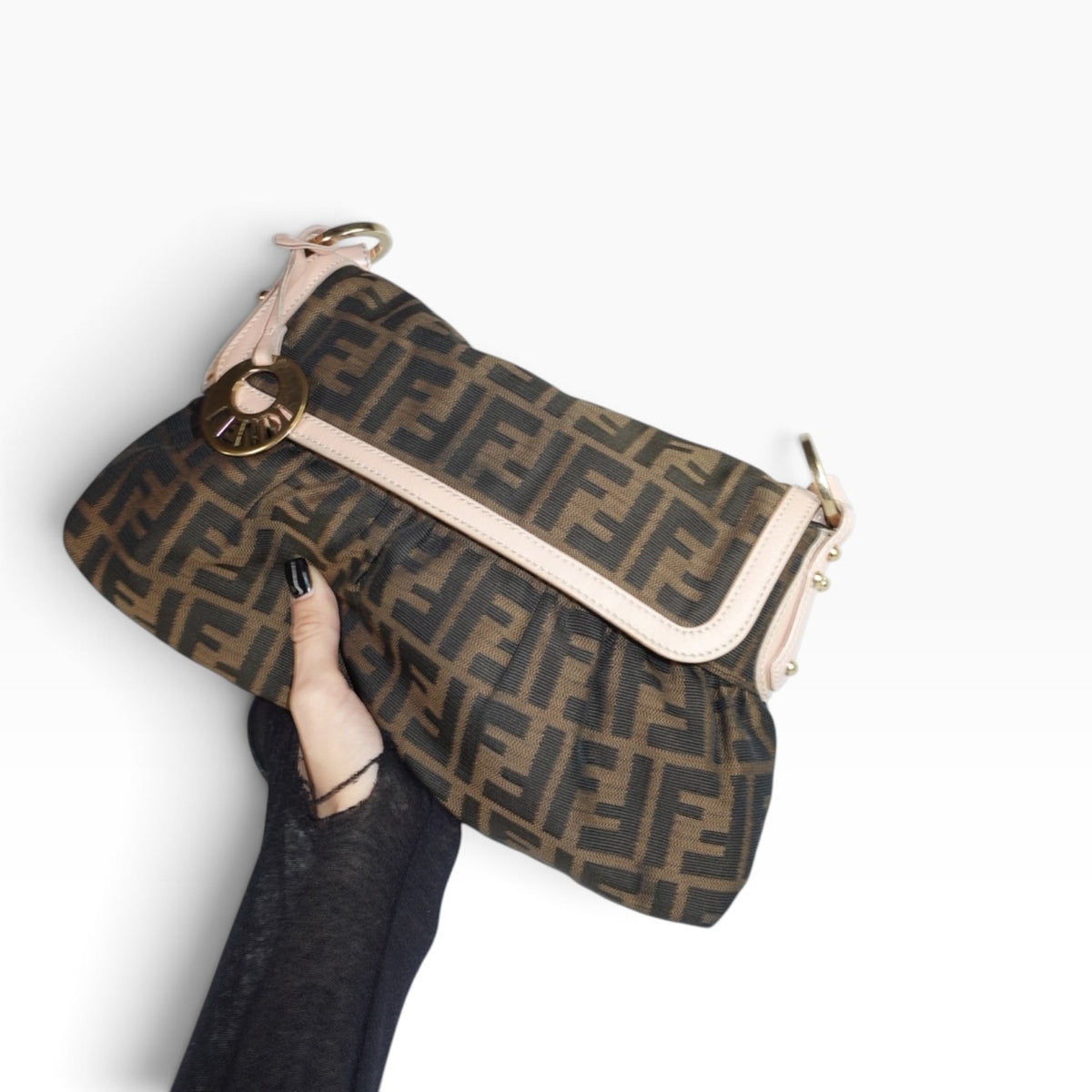 Vintage Fendi Chef Zucca handbag held in hand, showcasing the iconic FF monogram pattern and classic designer silhouette.