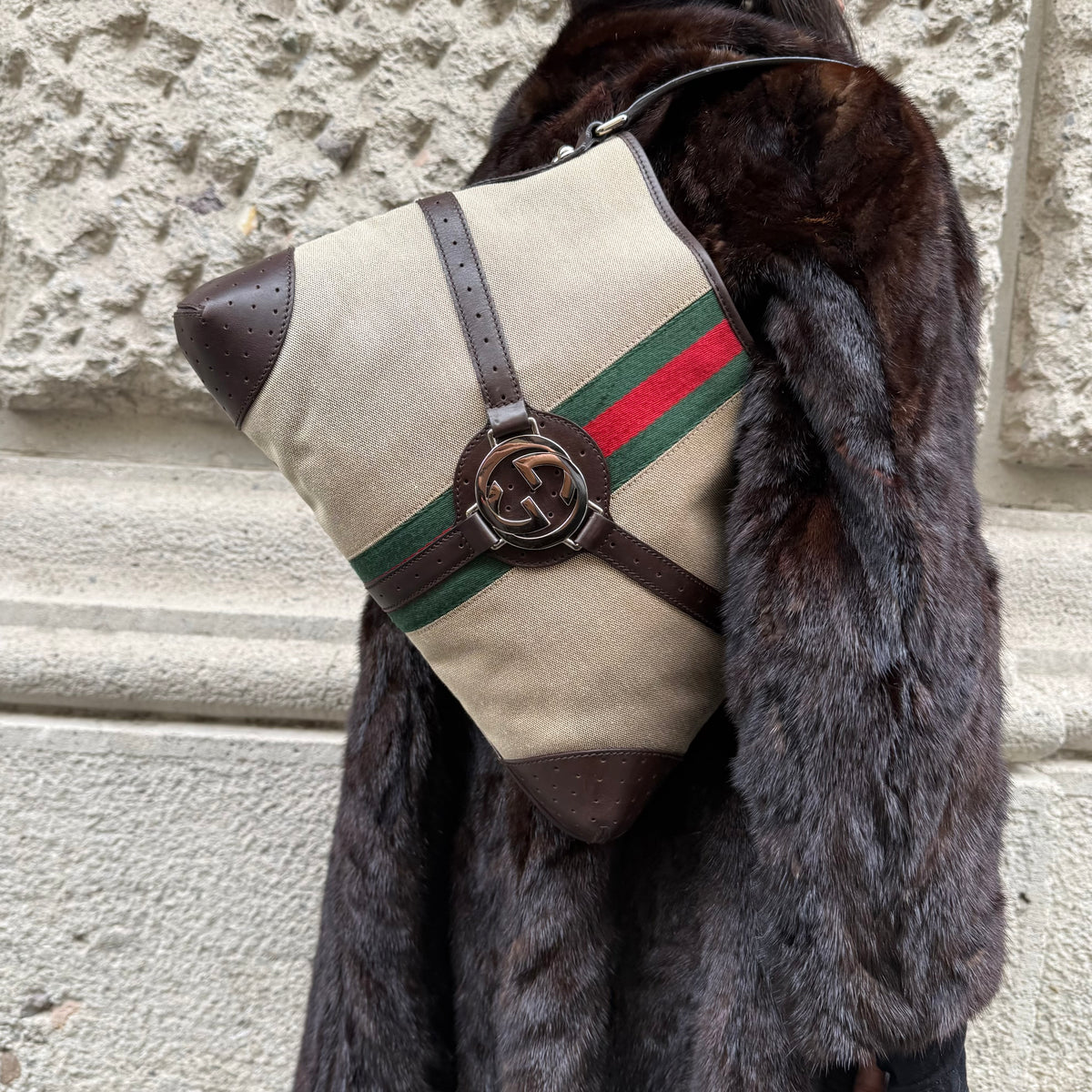 Gucci beige Reins Hobo Bag worn over the shoulder, featuring beige GG canvas, brown leather details, and signature hardware