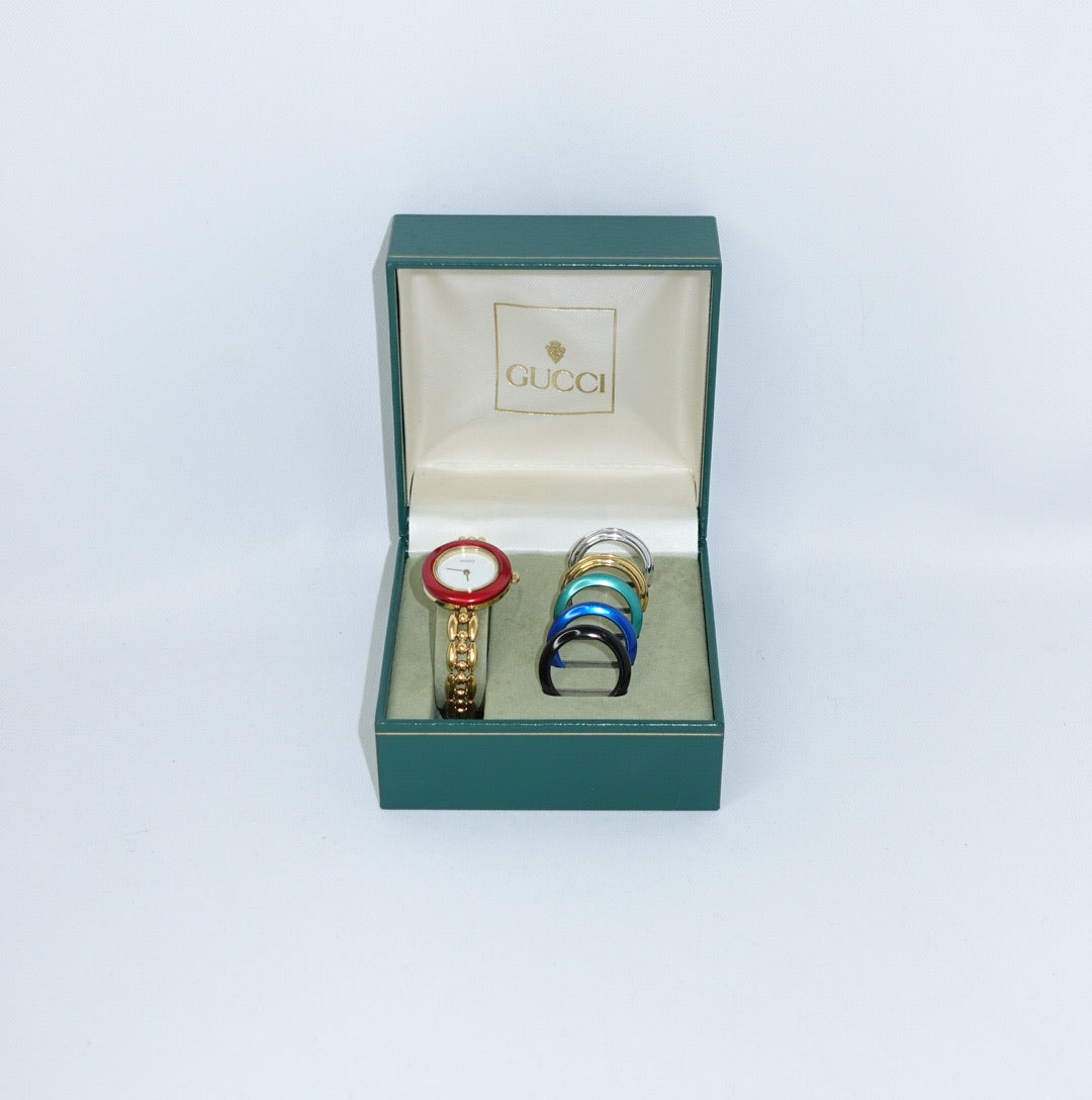 Vintage Gucci gold bezel watch with red interchangeable bezel