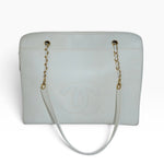 My Vintage Attire Chanel Maxi tote in white caviar leather with embossed CC logo and gold chain shoulder straps.
