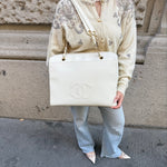 My Vintage Attire Chanel white caviar leather maxi tote bag with embossed CC logo and gold chain shoulder straps.