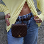 My Vintage Attire Chanel quilted chocolate brown caviar leather belt bag with gold CC logo worn on waist.