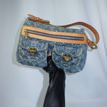 Front view of a Louis Vuitton Denim Baggy Monogram shoulder bag featuring signature blue monogram denim, leather trim, and gold-tone hardware.