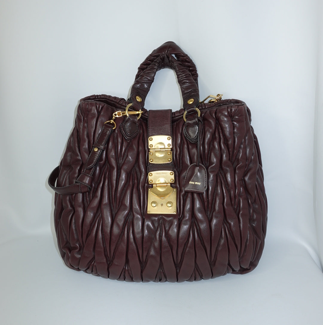 Miu Miu Burgundy Maxi Coffer Bag front view with signature matelassé leather