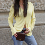 My Vintage Attire Chanel quilted chocolate brown caviar leather belt bag with 24k gold-plated CC logo worn on waist.