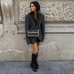 My Vintage Attire Chanel chessboard patent leather and tweed flap bag with silver CC logo worn by a woman.