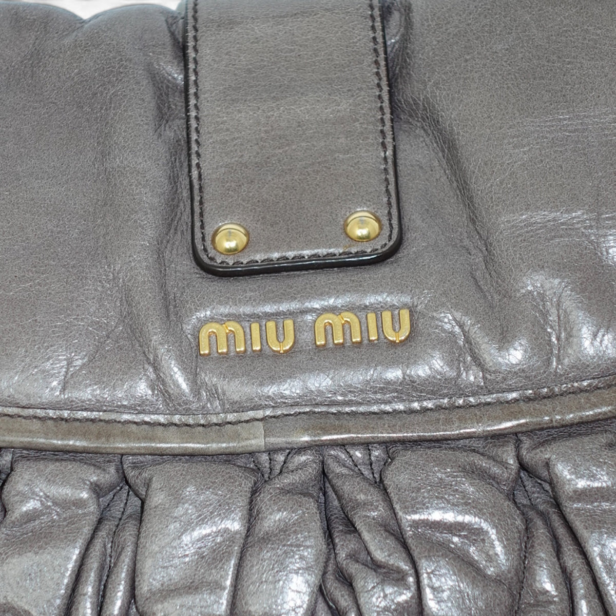 My Vintage Attire Miu Miu grey matelassé lambskin shoulder bag with gold-tone logo and hardware details.