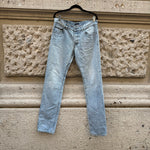 Front view of Prada light blue slim-fit jeans featuring a classic five-pocket design, vintage wash, and minimalist luxury styling.
