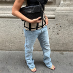 Model wearing Prada light blue slim-fit jeans styled with a modern casual outfit, showcasing the flattering fit and timeless designer aesthetic.